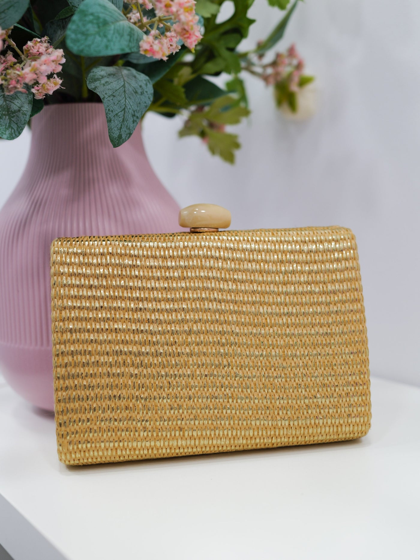 Gold raffia clutch