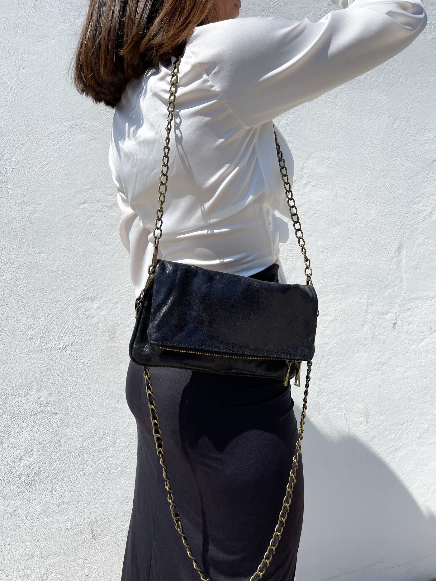 Black leather bag with shiny chains